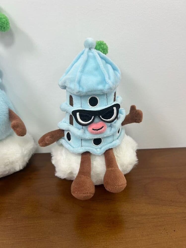 Custom blue character plush toy held in hand